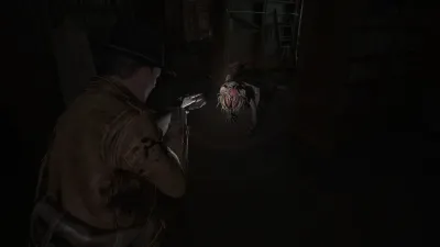 Protagonist examining a small bloodied object in a dark room